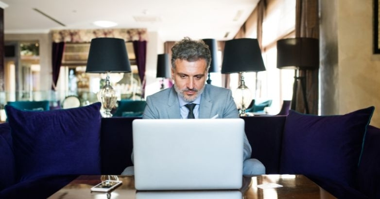 Travel website design mistakes concept with user reviewing site performance on laptop